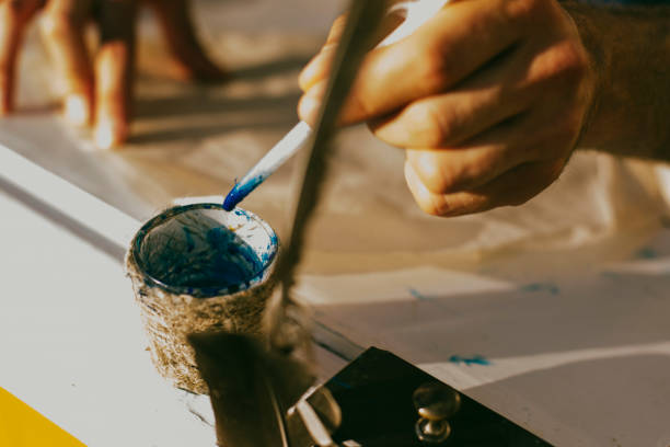 istock Human hands write a bird pen, ancient way of writing 1086704306