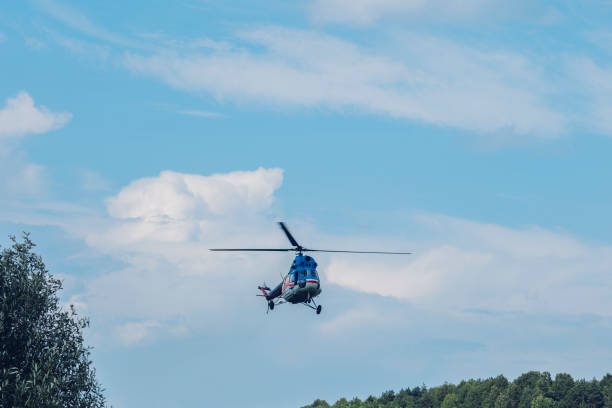 istock Flying helicopter against the blue sky with clouds 1086704708