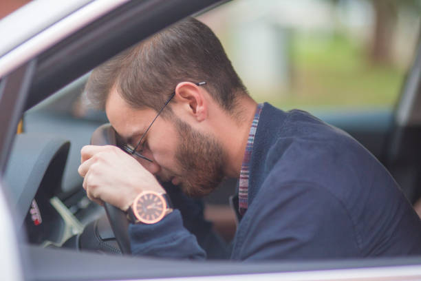 istock man leaning his head on steering wheel after accident 1086707686