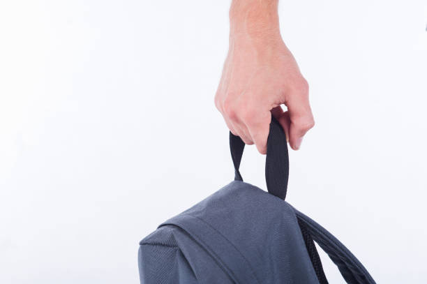 istock Male hand holds the handle of a backpack close up. 1086707800