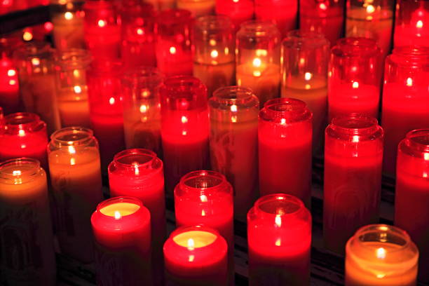 Hope: Light in the darkness: group of burning candlelight inside church on black background