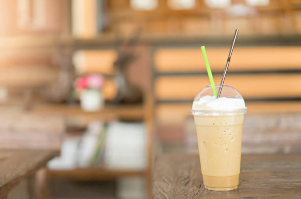istock Iced coffee in plastic glass on wooden table. 1086717136