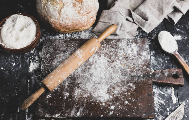 istock baked bread, white wheat flour, wooden rolling pin 1086725744