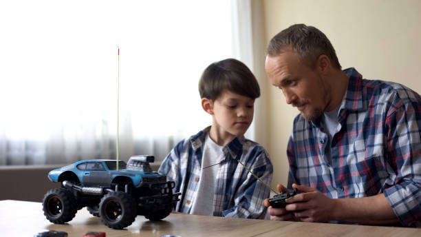 istock Father and son operating radio-controlled car, leisure activity, birthday gift 1086727630