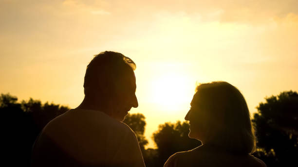 istock Happy aged spouse looking each other, romantic date at sunset, tender relations 1086727726