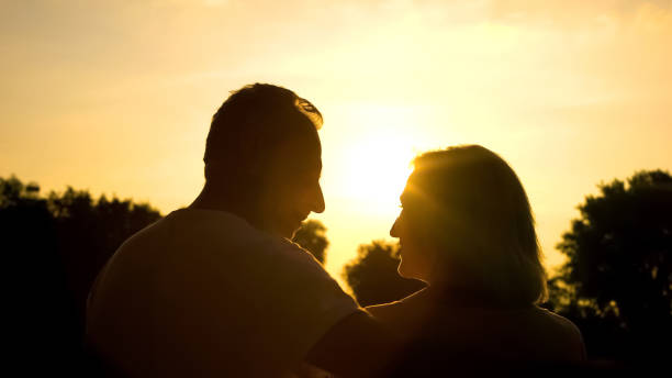 istock Happy retired spouse looking each other, spending time together in sunset park 1086727802