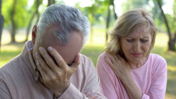 istock Mature couple crying sitting outdoors, incurable disease, retirement problem 1086728392