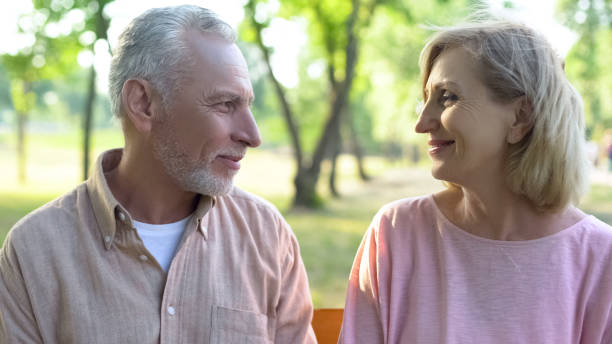 istock Smiling man and woman looking each other, romantic relations, date happiness 1086728568