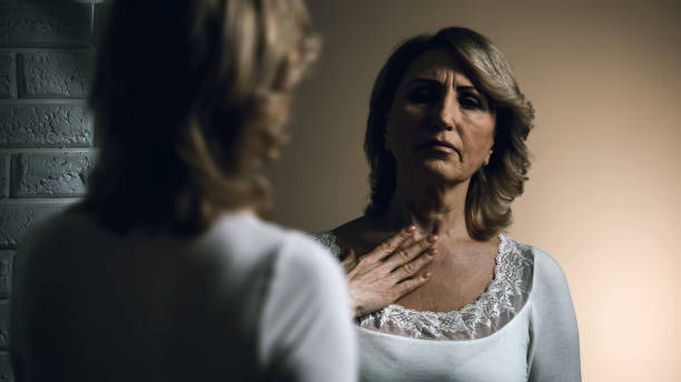 istock Sad senior female looking in mirror with disgust, aging problem, insecurities 1086728696