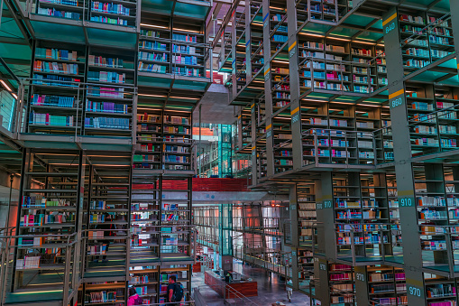 Mexico city, Mexico/ August, 31, 2018: Full shot of people studying and multiple shelfs full of books in the most famous and biggest library of Mexico: Jose Vasconcelos