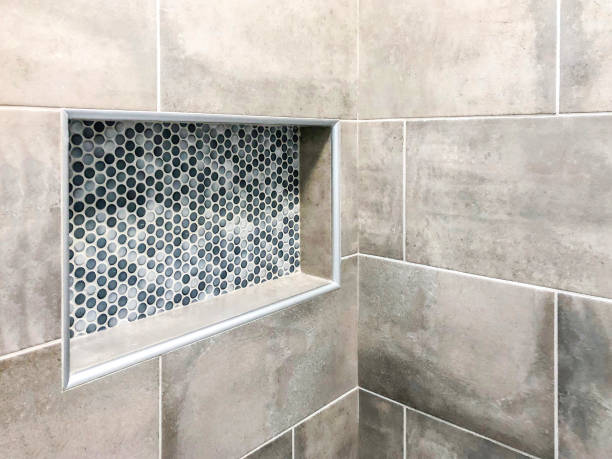Modern bathroom wall porcelain tiles in gray color tone with custom decorative rectangular wall niche for shampoo and soap Modern bathroom wall porcelain tiles in gray color tone with custom decorative rectangular wall niche for shampoo and soap roof tile stock pictures, royalty-free photos & images