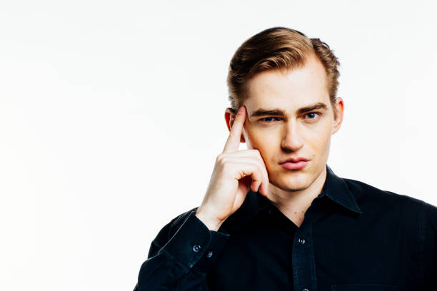 Portrait of a young man in a casual black shirt, isolated on white studio background