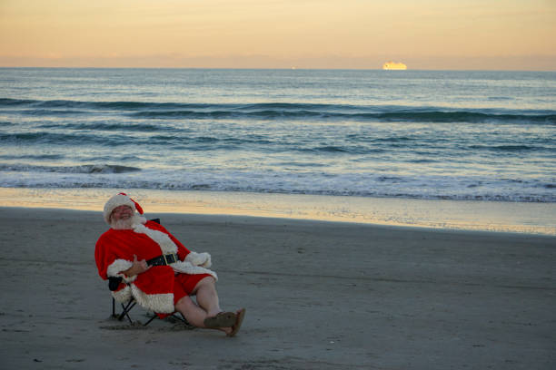 Santa Claus Christmas relaxation on Cocoa Beach Cocoa Beach vacation Santa Claus relaxing and smiling cocoa beach photos stock pictures, royalty-free photos & images