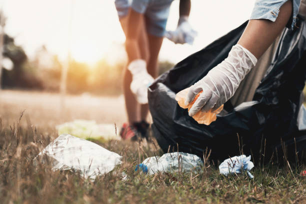 istock woman hand picking up garbage plastic for cleaning at park 1086760076
