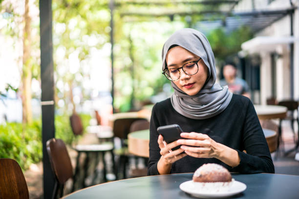 istock Young Malaysian woman using a smart phone 1086761592