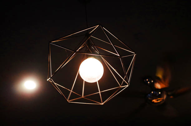 istock Black orange ceiling lamp with energy saving fluorescent light bulb 1086768542