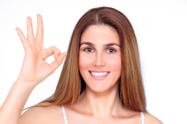 istock Beautiful laughing woman shows everything ok with her hand 1086803094