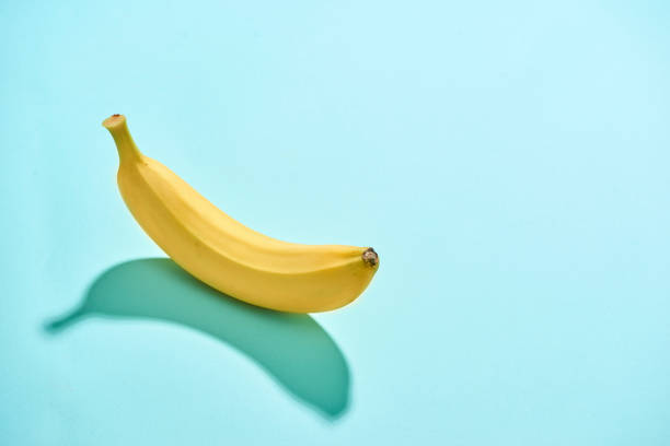 istock Ripe banana isolated on blue background 1086803440