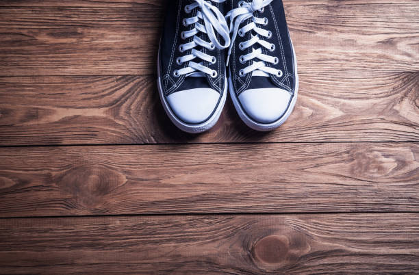 istock Sneakers on a wooden background. 1086803872