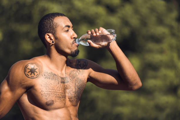 istock Athletic man drinking water after workout outdoors 1086805894