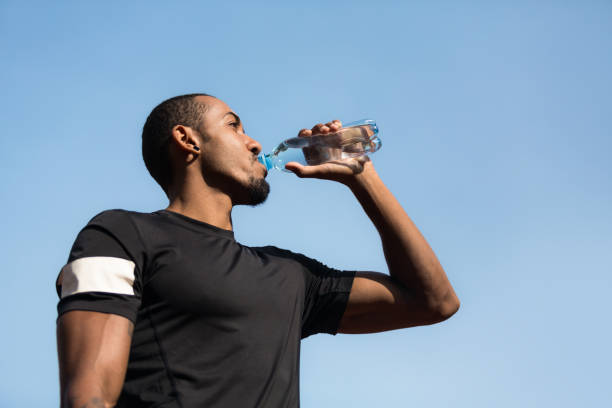 istock Man resting and drinking water after running 1086805900