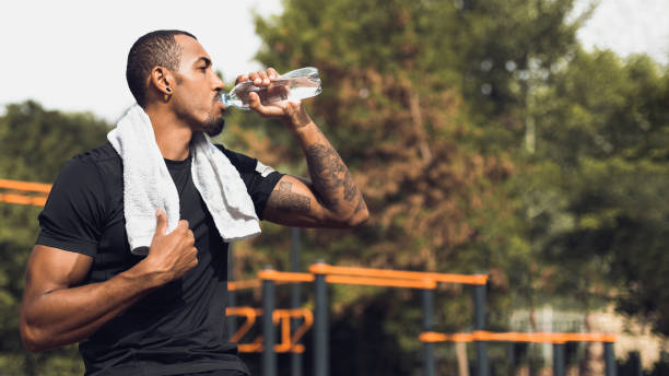 istock Sporty man drinking water after workout outside 1086805910