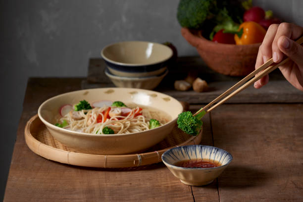 istock Hand uses chopsticks to pickup tasty broccoli 1086807378