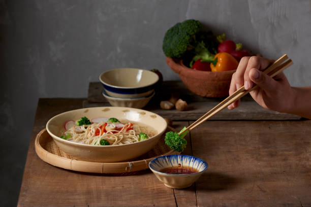 istock Hand uses chopsticks to pickup tasty broccoli 1086807522