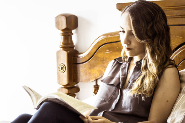 istock Young modern woman reading a book 1086808720