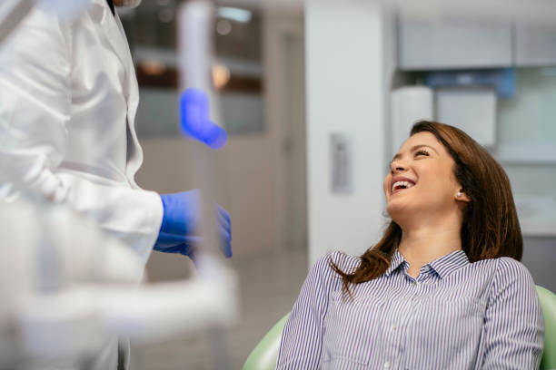 istock Young beautiful woman at dentist for routine checkup 1086810420
