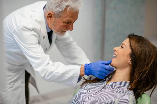 istock Young beautiful woman at dentist for routine checkup 1086812548