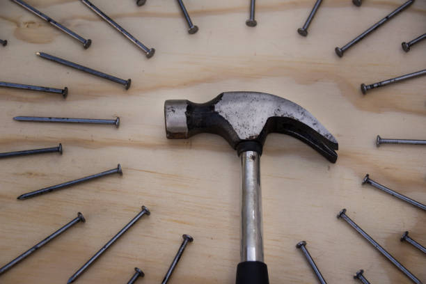 istock Hammer and nails on wood background 1086812552