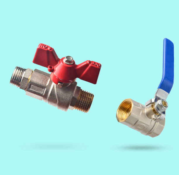 Two Metal ball valve with red and blue handle isolated on blue background. Minimalism