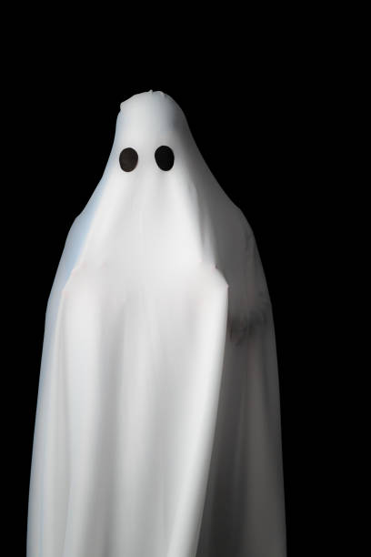 istock Someone covered with white cloth with big black eyes on black background look like ghost in night. Concept for funny playing in halloween festival 1086817554