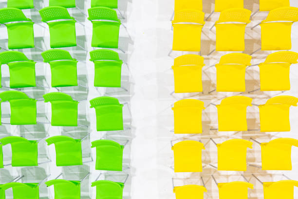 Rows of bright color chairs arranged in meeting room ready to sit. high angle shoot, top view photo.