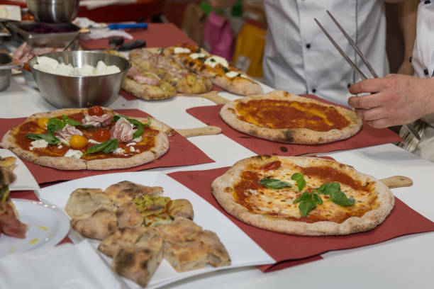 istock Pizza Maker who Prepares Delicious Pizzas with Cheese ad Tomatoes 1086827942