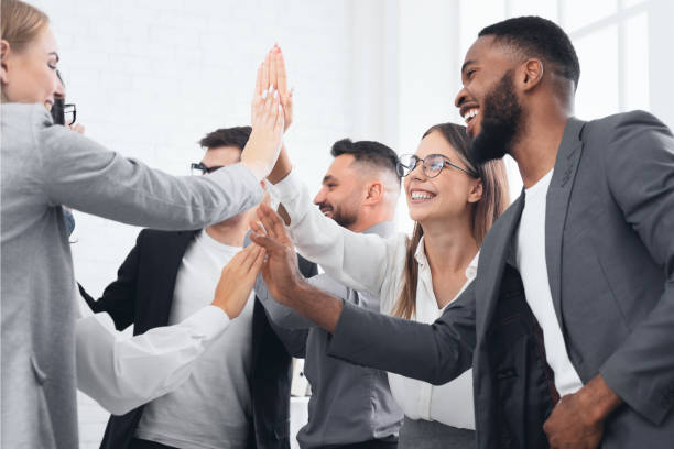 istock Team achievement, diverse business people giving high five 1086831884