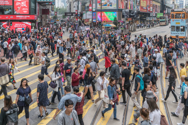 Hong Kong. Hong Kong Island. Large group of pedestrian crossing a street in the Financial District.