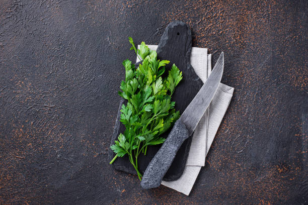 istock Culinary background with knife, parsley and cutting board 1086834692