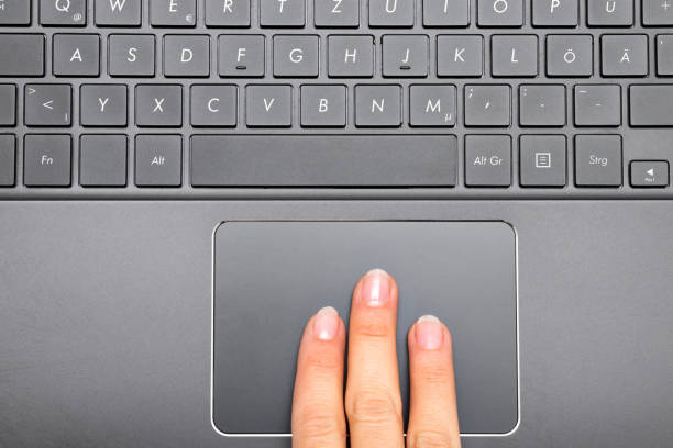 Three fingers of a woman on Notebook Touchpad Three fingers of a woman on Notebook Touchpad touchpad stock pictures, royalty-free photos & images