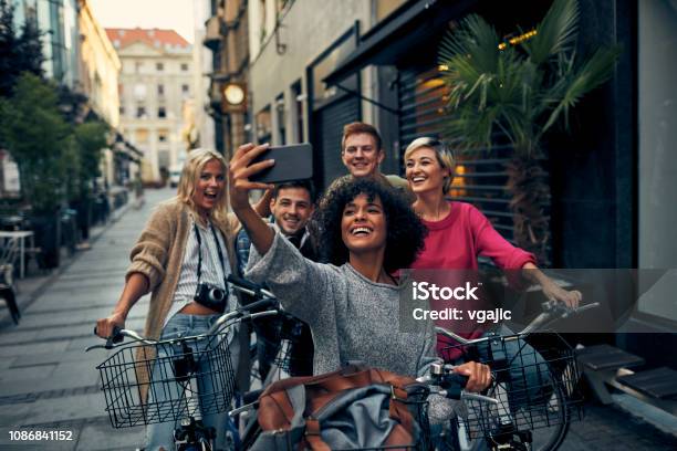 Friends Riding Bicycles In A City Stock Photo - Download Image Now - Friendship, Travel, Cycling