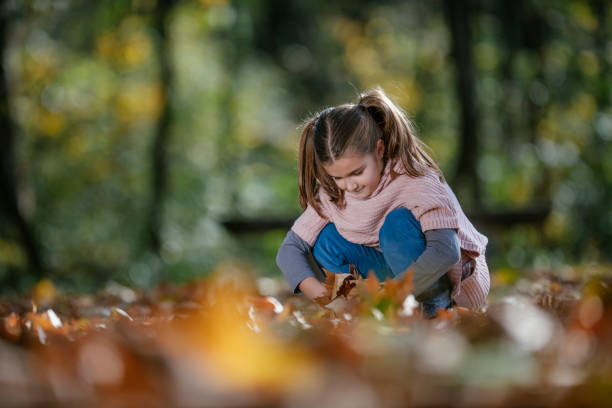 istock Girl in autumn park 1086845066