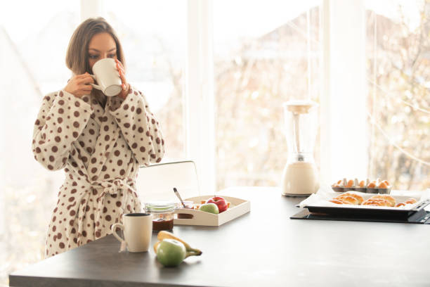 istock Woman enjoying morning tea in the kitchen 1086845212