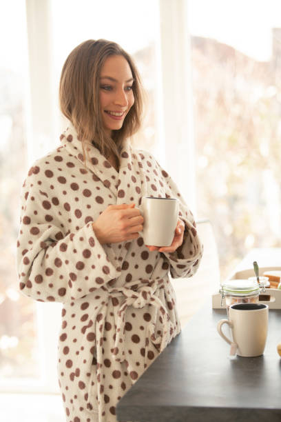 istock Happy woman having tea at the kitchen counter 1086845214