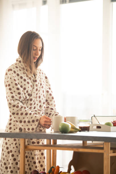 istock Young woman is preparing breakfast for two 1086845216