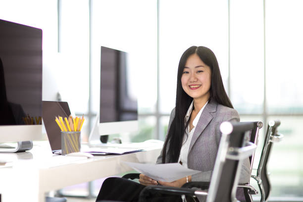 Happy business woman in office.