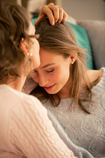 istock Mother kissing her daughter on forehead 1086845818