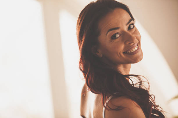 istock Beautiful brunette looking over her shoulder and smiling 1086847244