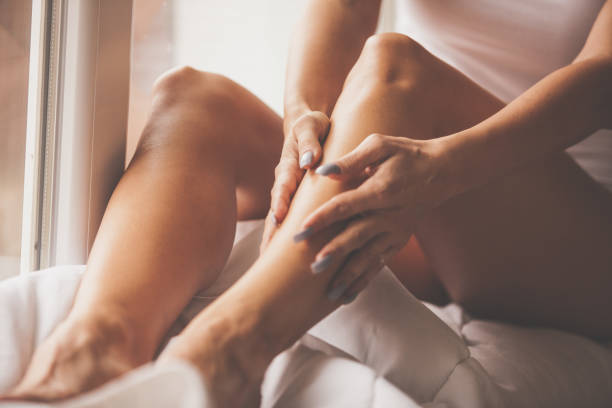 istock Woman massaging her legs at home 1086847472