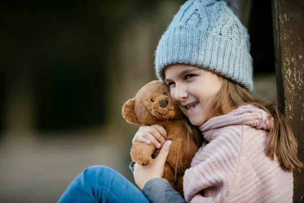 istock Smiling girl with teddy-bear 1086847782